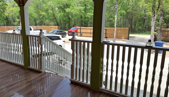 wooden deck featuring a forest view and fence