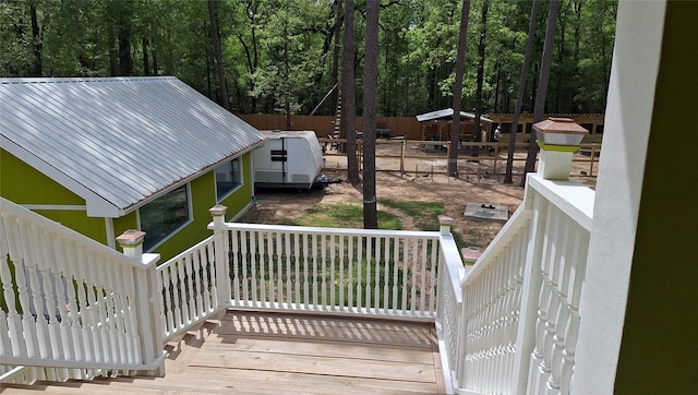 wooden deck with a porch and fence