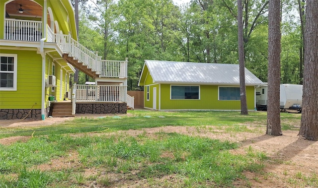 exterior space featuring a wooden deck, stairway, and a ceiling fan