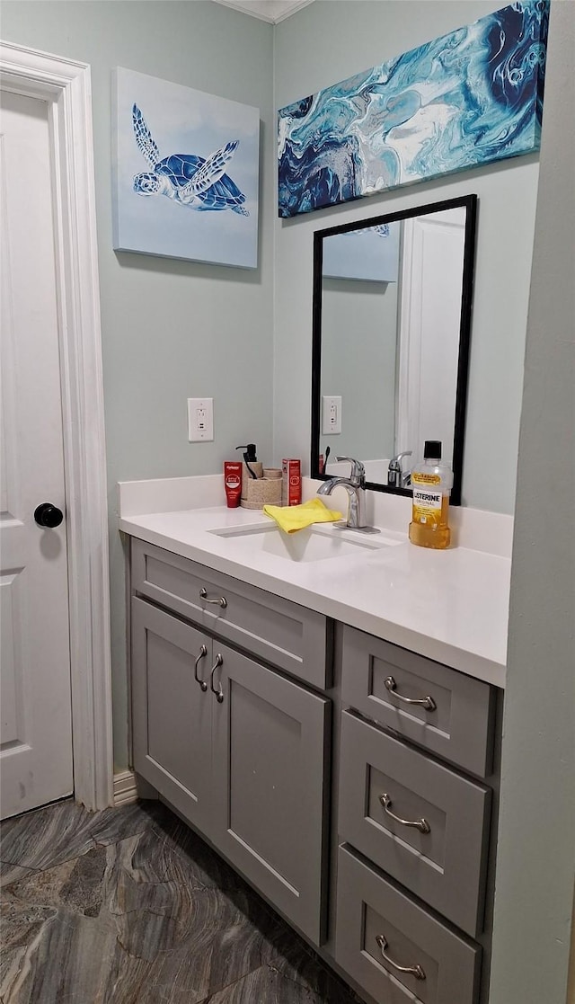 bathroom with marble finish floor and vanity