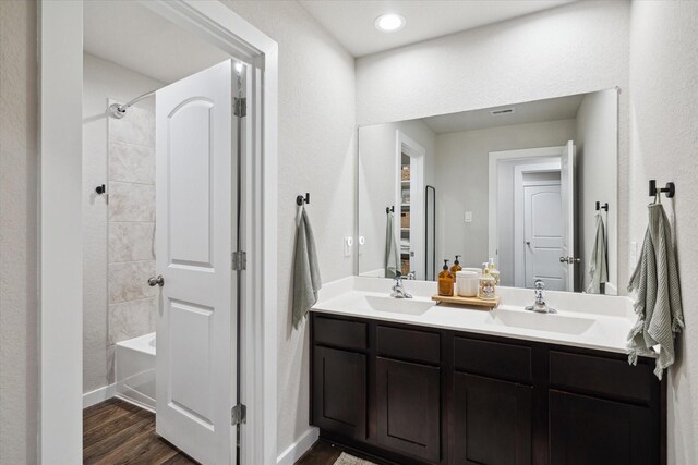 9833 Glen Brook Ln, Magnolia, TX 77354 - full bath with double vanity, wood finished floors, and washtub / shower combination