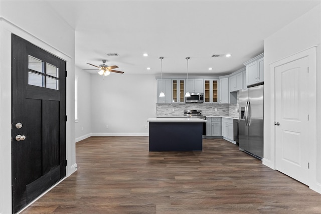 1603 Oleander Dr, La Marque, TX 77568 - kitchen with stainless steel appliances, a kitchen island, light countertops, glass insert cabinets, and ceiling fan