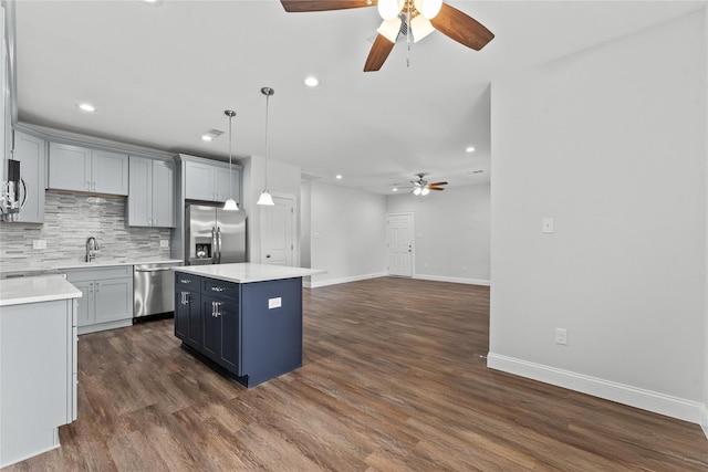 1603 Oleander Dr, La Marque, TX 77568 - kitchen featuring appliances with stainless steel finishes, ceiling fan, decorative backsplash, light countertops, and recessed lighting
