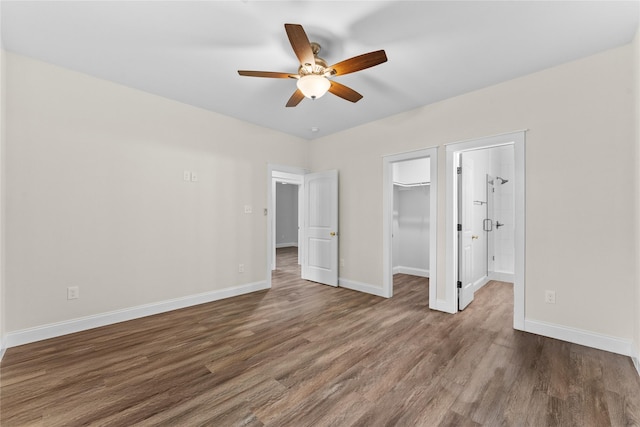 1603 Oleander Dr, La Marque, TX 77568 - unfurnished bedroom featuring wood finished floors, baseboards, a spacious closet, a closet, and a ceiling fan