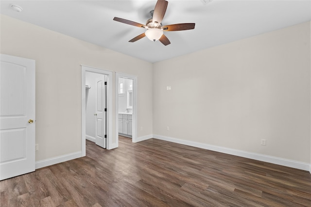 1603 Oleander Dr, La Marque, TX 77568 - unfurnished bedroom with dark wood finished floors, baseboards, connected bathroom, and ceiling fan