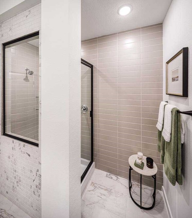 211 Cypress Pond Pl, Montgomery, TX 77316 - full bath with marble finish floor, a textured ceiling, and a stall shower