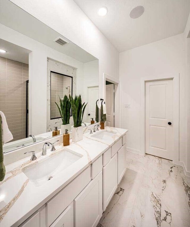 211 Cypress Pond Pl, Montgomery, TX 77316 - bathroom featuring marble finish floor, visible vents, a sink, and double vanity