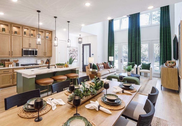 211 Cypress Pond Pl, Montgomery, TX 77316 - dining space with a high ceiling, a healthy amount of sunlight, light wood finished floors, and recessed lighting