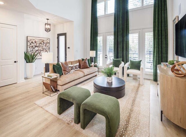 211 Cypress Pond Pl, Montgomery, TX 77316 - living room featuring a high ceiling, a notable chandelier, and light wood finished floors