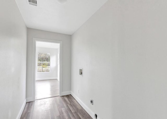 clothes washing area with wood finished floors, hookup for an electric dryer, laundry area, visible vents, and hookup for a washing machine