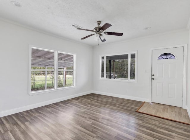 entryway with baseboards, wood finished floors, and crown molding