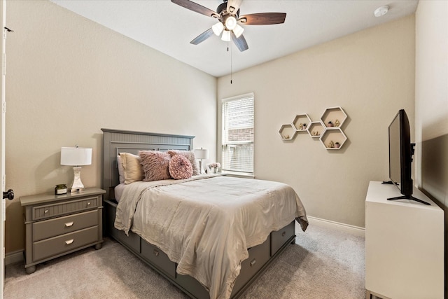bedroom with ceiling fan, light carpet, and baseboards
