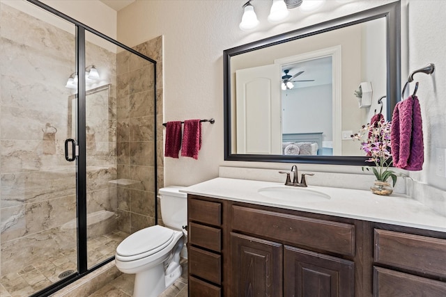 ensuite bathroom with connected bathroom, toilet, vanity, and a stall shower