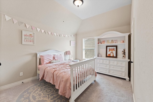 bedroom with baseboards, lofted ceiling, and carpet