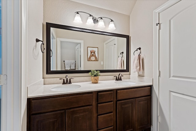 full bathroom featuring double vanity and a sink