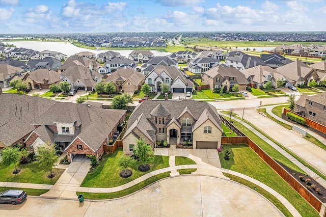 drone / aerial view featuring a water view and a residential view