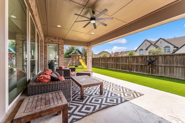 view of patio / terrace featuring a ceiling fan, a fenced backyard, and a playground