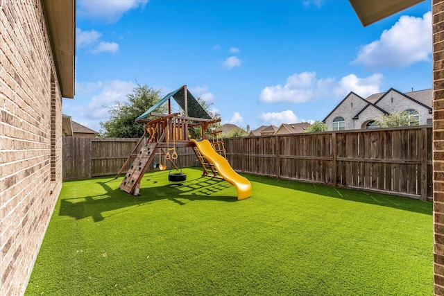 view of yard featuring a fenced backyard and a playground
