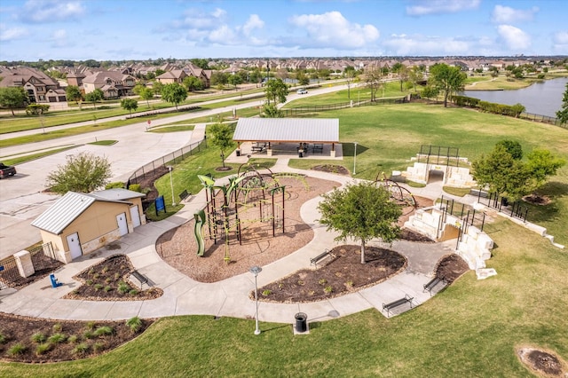 drone / aerial view with a residential view and a water view