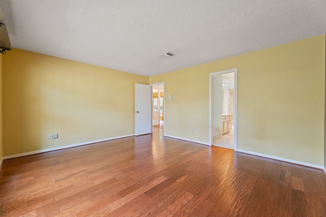 3410 Park Point Dr, Houston, TX 77339 - empty room with wood finished floors, baseboards, and a textured ceiling