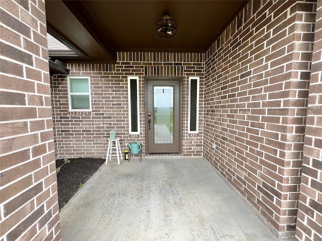 property entrance with brick siding