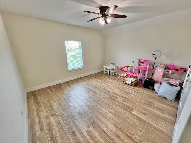 playroom featuring a ceiling fan, baseboards, lofted ceiling, and wood finished floors