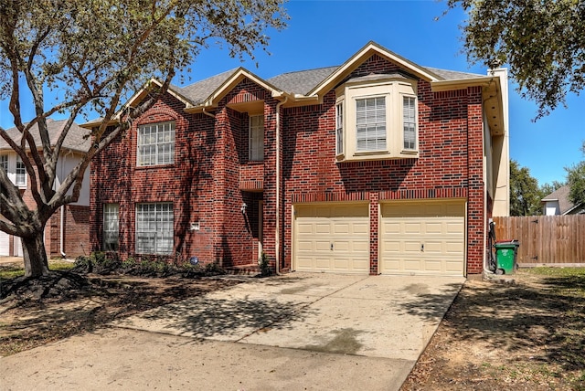 view of front of home with brick siding, a garage, fence, and concrete driveway
