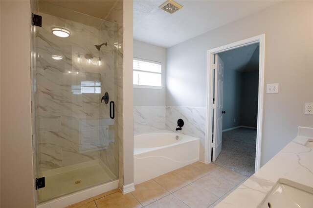 bathroom featuring visible vents, a garden tub, a marble finish shower, and tile patterned floors