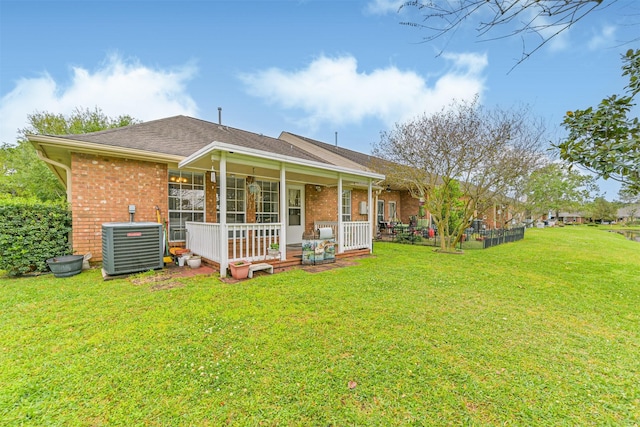 831 Woodfern Glen Ln, Pearland, TX 77584 - rear view of house featuring brick siding, a yard, central AC, covered porch, and roof with shingles