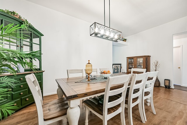 831 Woodfern Glen Ln, Pearland, TX 77584 - dining room featuring a chandelier, light wood-style flooring, and baseboards