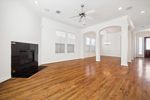 5309 Elm St, Houston, TX 77081 - living area with crown molding, a tiled fireplace, wood finished floors, baseboards, and visible vents