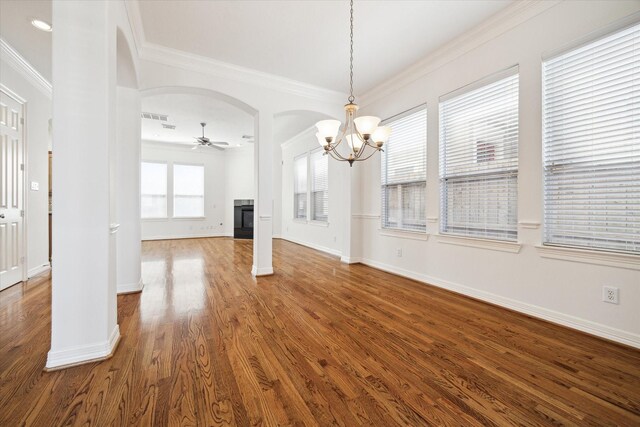 5309 Elm St, Houston, TX 77081 - unfurnished dining area with crown molding, wood finished floors, ceiling fan with notable chandelier, visible vents, and arched walkways
