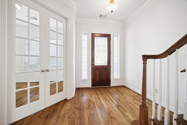 5309 Elm St, Houston, TX 77081 - entrance foyer with a wealth of natural light, french doors, wood finished floors, visible vents, and ornamental molding