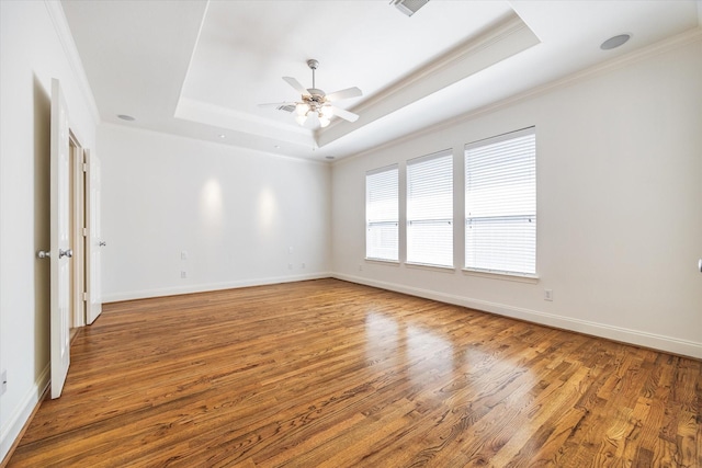 5309 Elm St, Houston, TX 77081 - spare room featuring a tray ceiling, baseboards, wood finished floors, and a ceiling fan