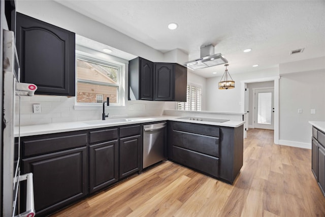 kitchen featuring black electric cooktop, a wealth of natural light, stainless steel dishwasher, and a sink
