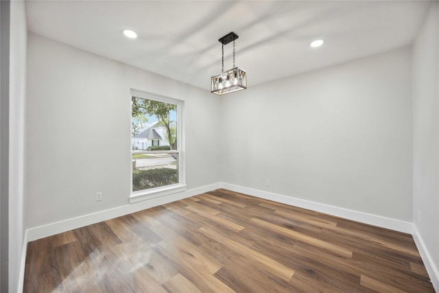 empty room featuring recessed lighting, dark wood finished floors, and baseboards