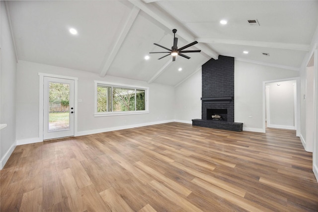 unfurnished living room with ceiling fan, vaulted ceiling with beams, light wood finished floors, and a fireplace