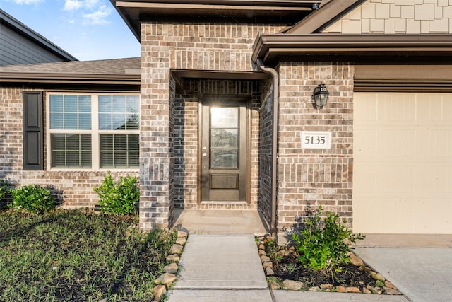 5135 Dunstable Manor Ln, Rosharon, TX 77583 - property entrance with brick siding, an attached garage, and roof with shingles
