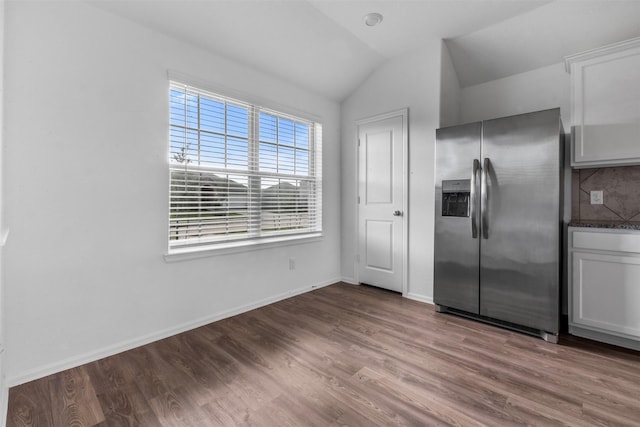 5135 Dunstable Manor Ln, Rosharon, TX 77583 - kitchen featuring stainless steel refrigerator with ice dispenser, vaulted ceiling, wood finished floors, white cabinetry, and dark countertops