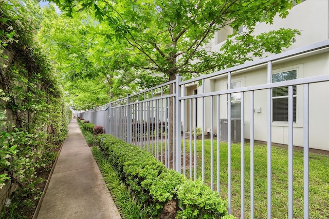 exterior space featuring central air condition unit and fence