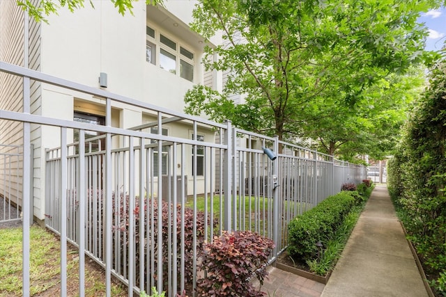 view of side of home with fence and stucco siding