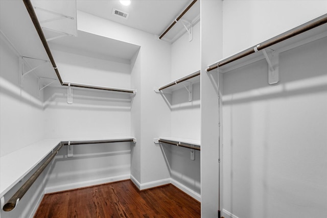 walk in closet featuring dark wood-style flooring and visible vents
