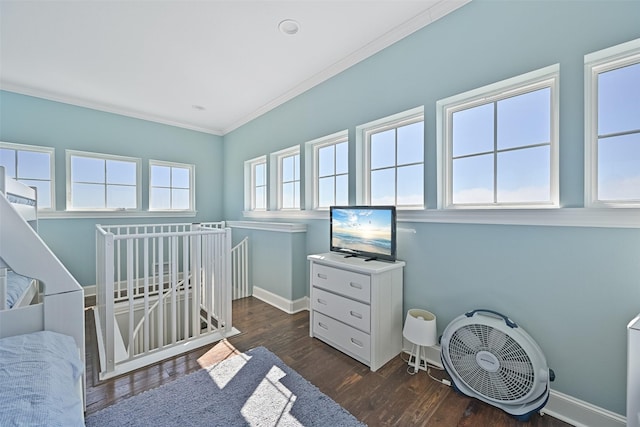 1243 Pilot Ln, Galveston, TX 77554 - bedroom featuring crown molding, baseboards, and dark wood-type flooring