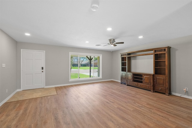 unfurnished living room featuring baseboards, wood finished floors, ceiling fan, and recessed lighting