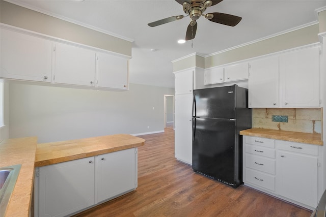 kitchen with white cabinets, wood finished floors, a ceiling fan, and freestanding refrigerator