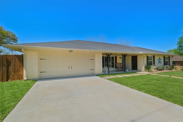 ranch-style house with brick siding, a garage, and a front yard