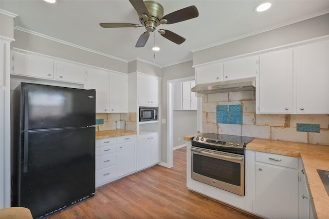 kitchen featuring light countertops, crown molding, stainless steel appliances, under cabinet range hood, and light wood finished floors