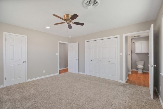 unfurnished bedroom with a closet, carpet, baseboards, and visible vents