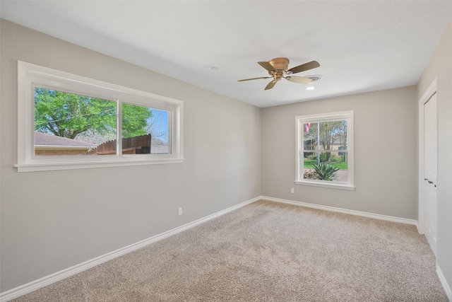 unfurnished bedroom with baseboards, carpet floors, a closet, and a ceiling fan