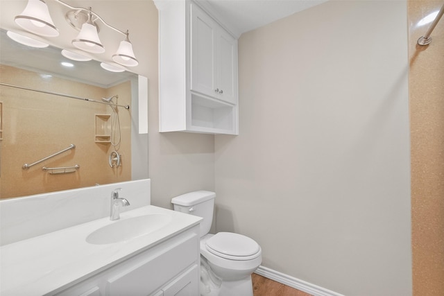 bathroom featuring a shower, vanity, toilet, baseboards, and wood finished floors